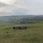 Bench on hill in countryside