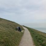 People on cliff bench