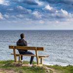 Person bench facing out to sea